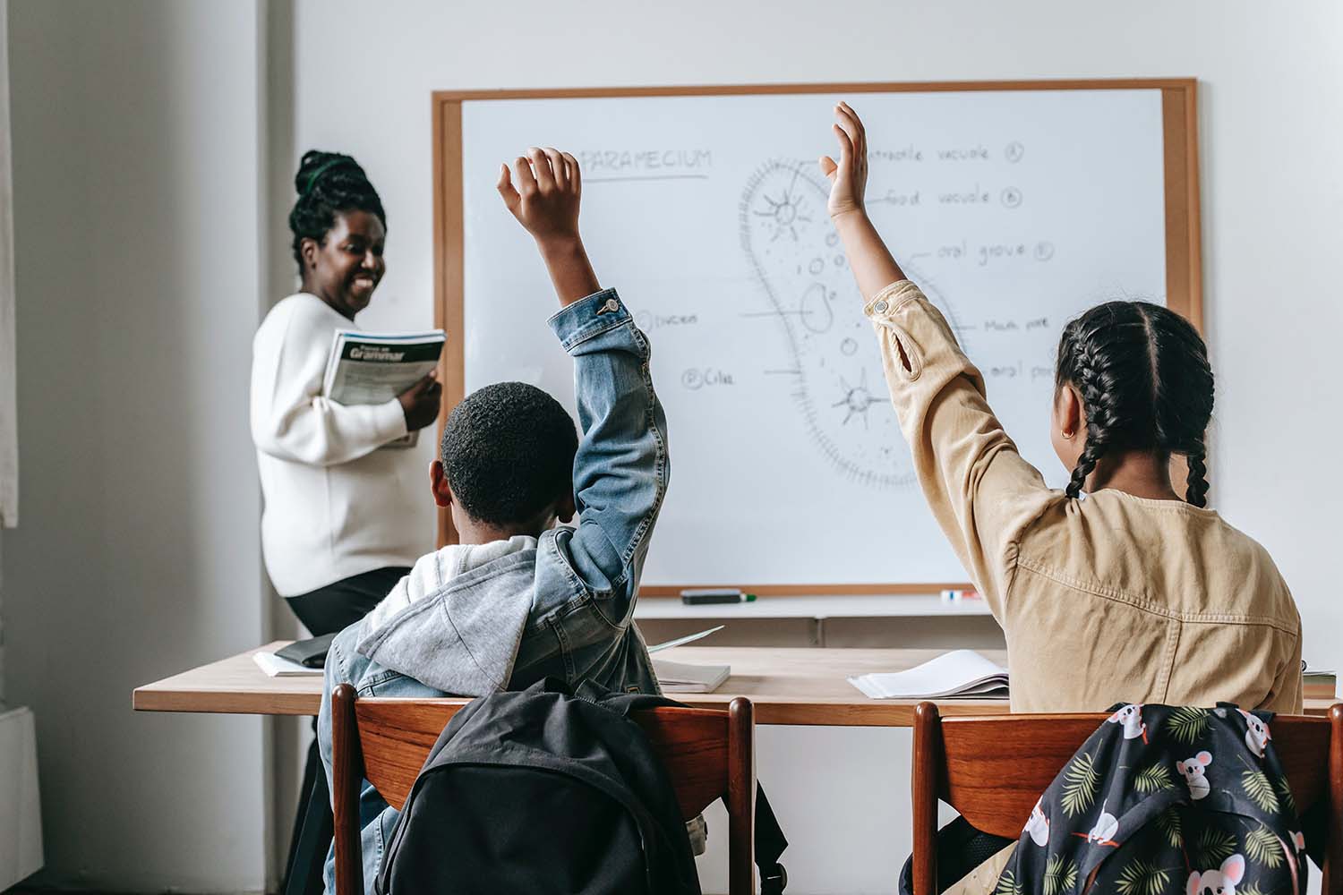 students writing on whiteboard